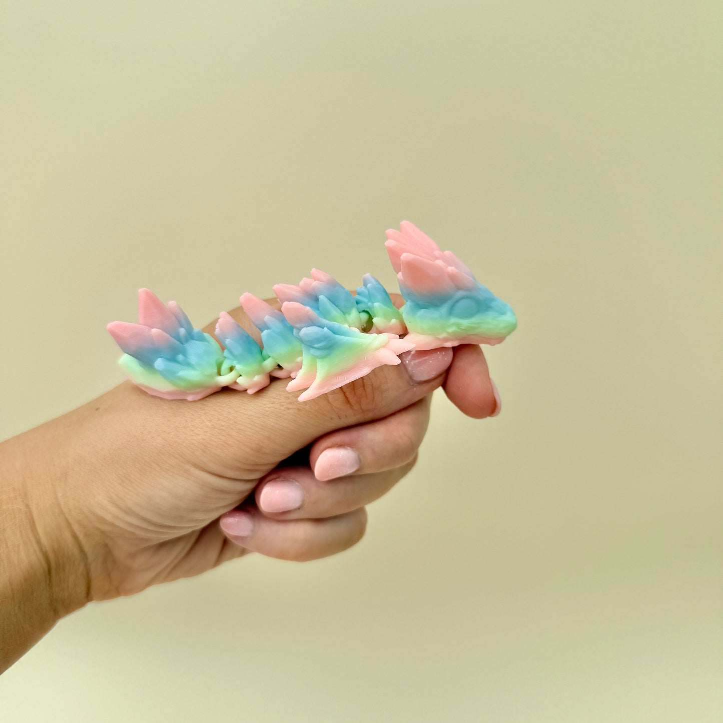 Colourful fidget dragon with unpredictable rainbow colour placement and articulated limbs.
