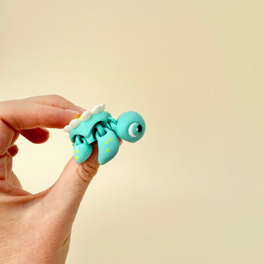 A handheld fidget turtle featuring a cute daisy detail on its shell for sensory play.