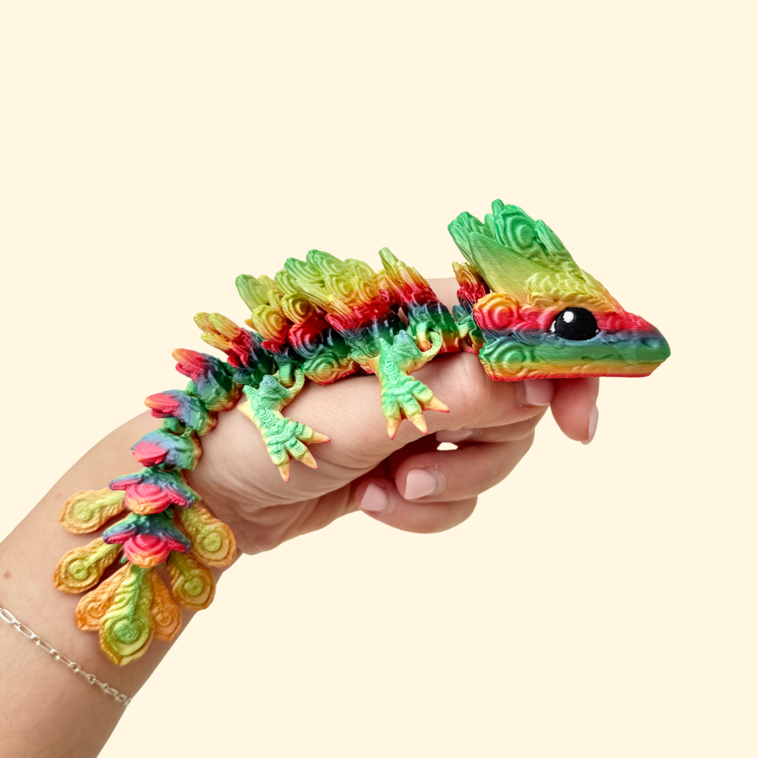 fully articulated peacock-inspired dragon fidget with feather-style textures and rainbow finish for tactile stimming and display