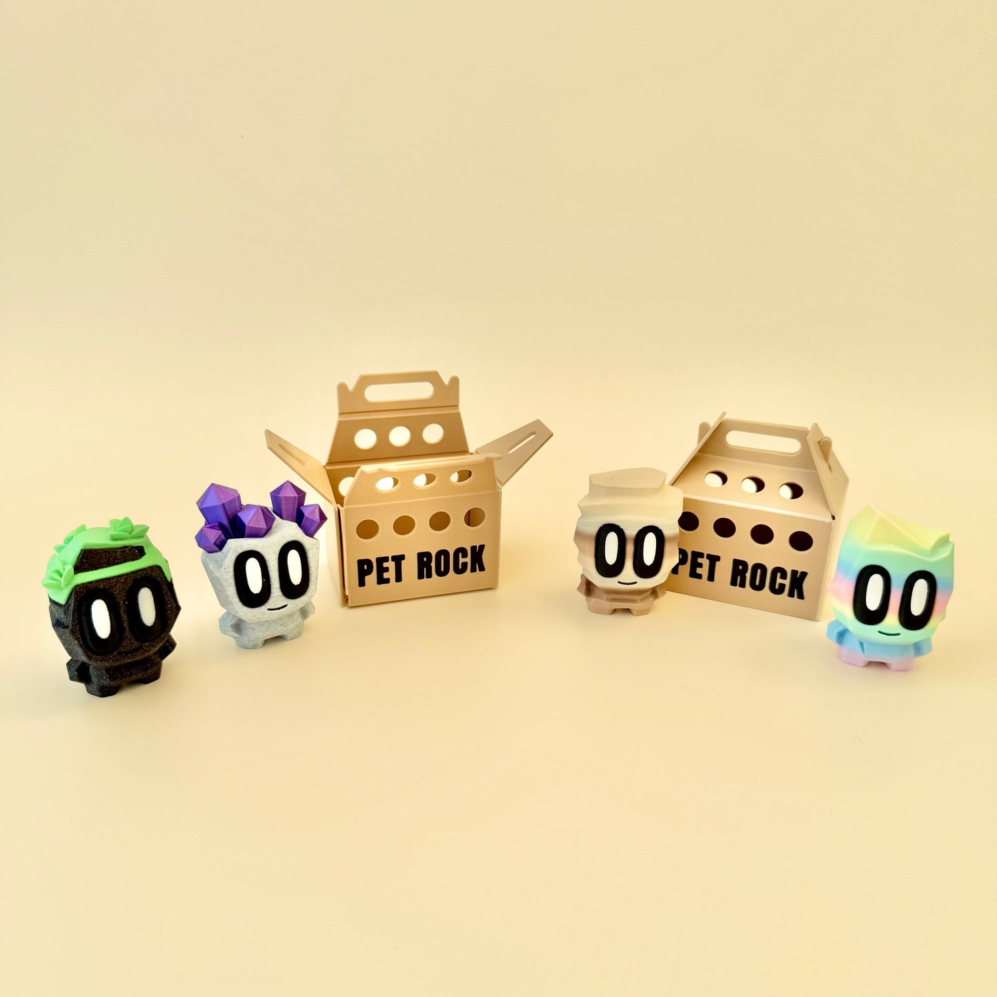A cute pet rock toy with big eyes, a smile, and a carry box, perfect for collecting and fidgeting.