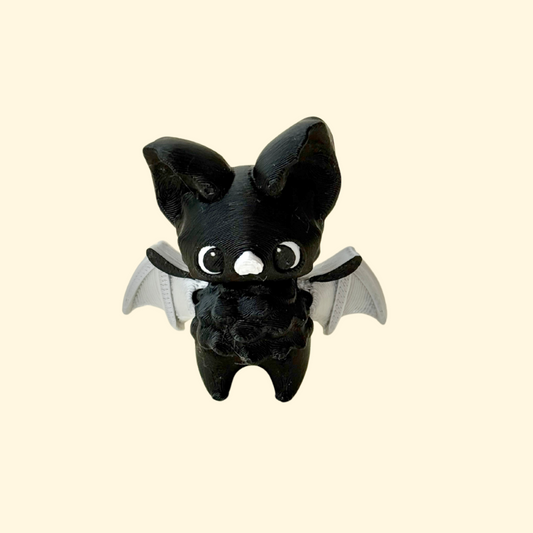 articulated bat-themed sensory fidget with moving wings and head; smooth curves with gentle raised details; silent for discreet stimming