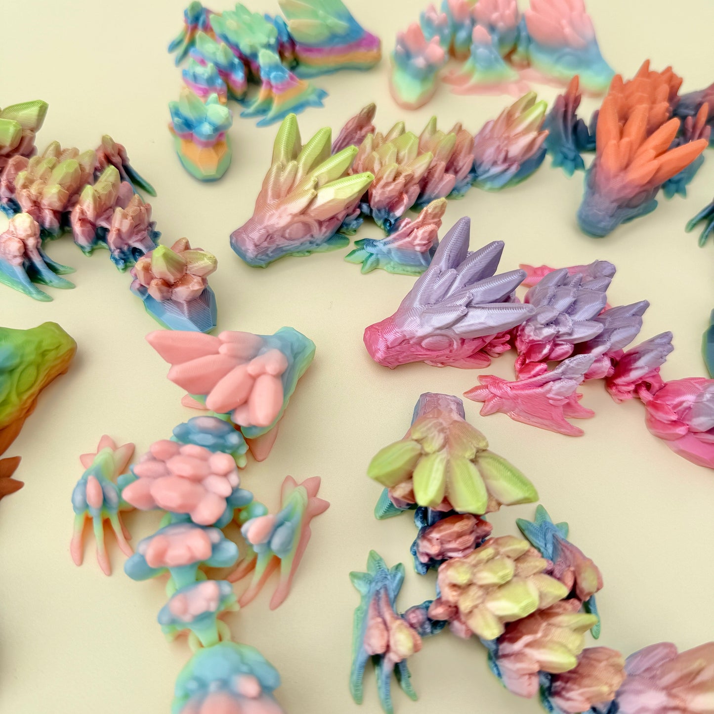 Miniature dragon fidget toy with shimmering rainbow tones and textured scales for tactile stimming.