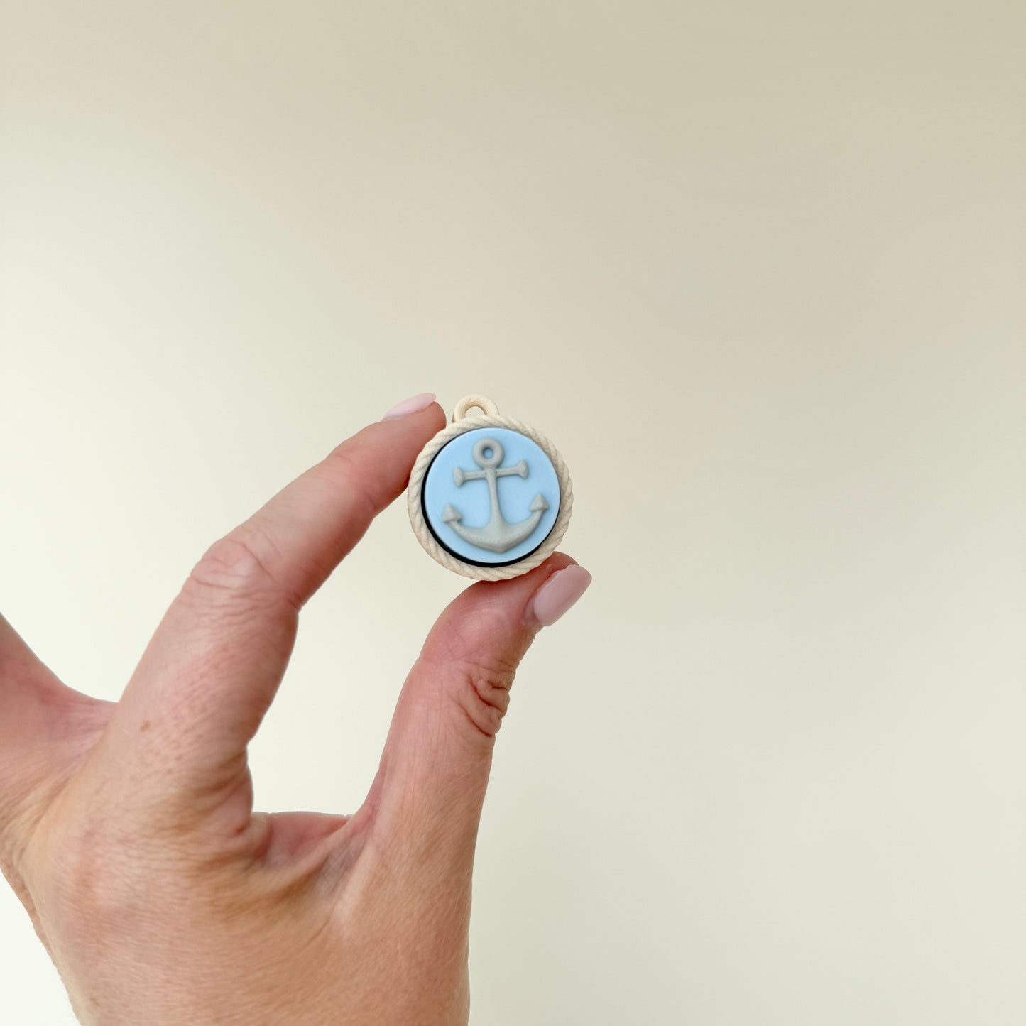 portable clicker fidget with raised anchor detail for sensory regulation