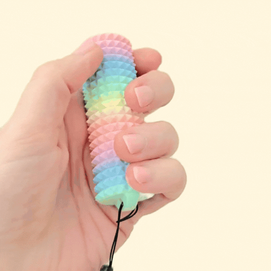 A compact fidget roller with a wrist strap for easy attachment to bags or keys.