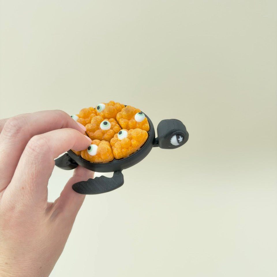 tactile fidget shell with seven pops, textured bubbles for stimming