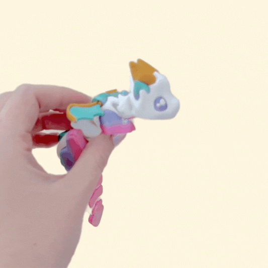 Smooth, flexible segments for calming fidgeting; white body with bold accents and tilt-to-pose wings.