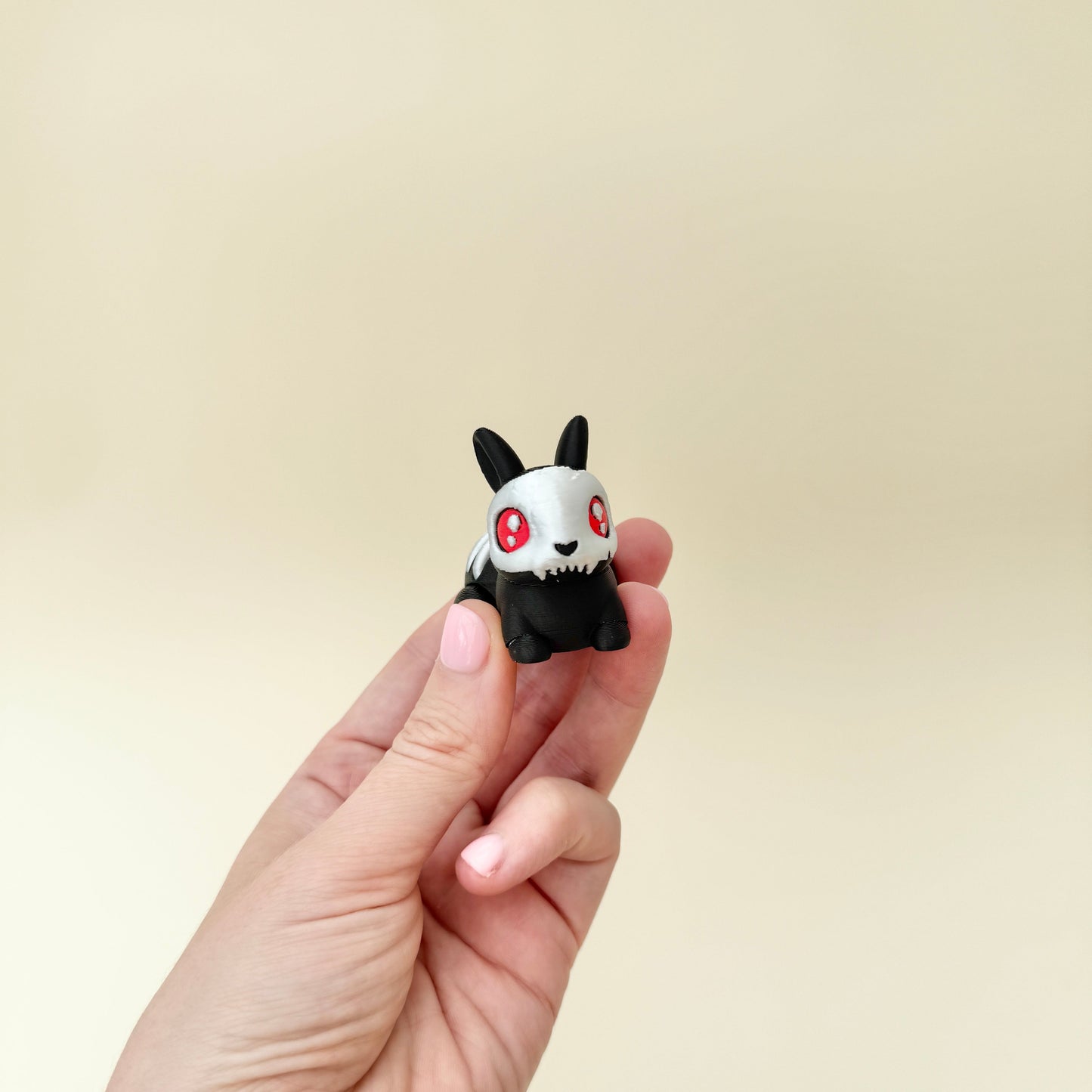 small bunny with bone-style details and basket handle for portable grounding