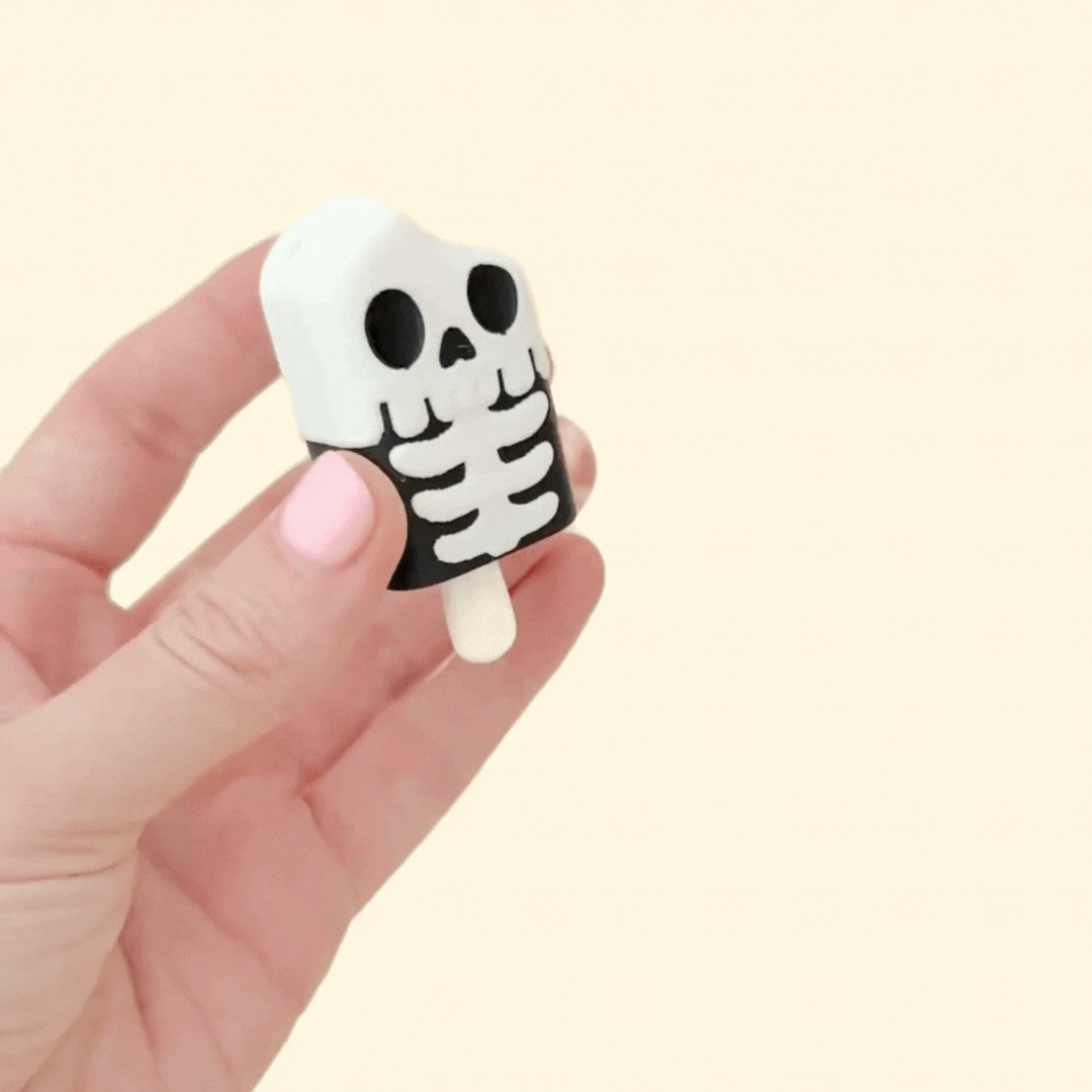 skeleton lolly shaped clicker fidget with keyring-ready attachment and tactile details