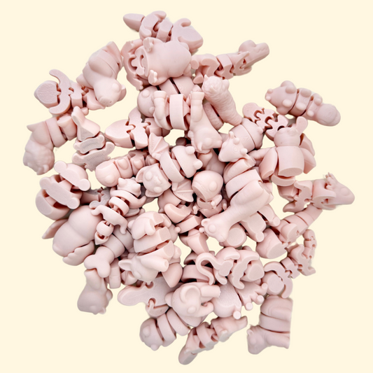 A selection of SoftTone Mini Pets in a silky, muted peachy-pink colour, fully articulated for sensory fidgeting.