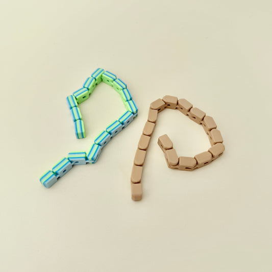 Neutral-coloured tactile fidget tool with bendable links and no sound during use.