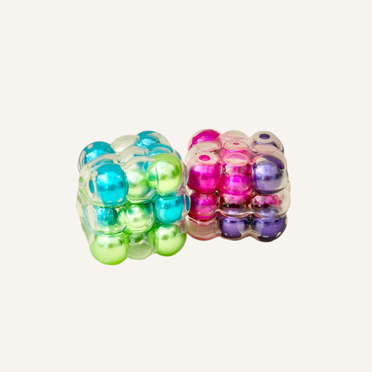 Handheld sensory fidget combining rolling bead texture with gentle noise, ideal for desk breaks and at-home fidgeting.