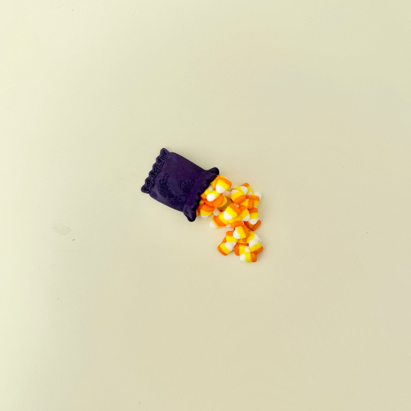 Tiny flexible candy-corn ornament-style fidget; lightweight, tactile, and fun for October.