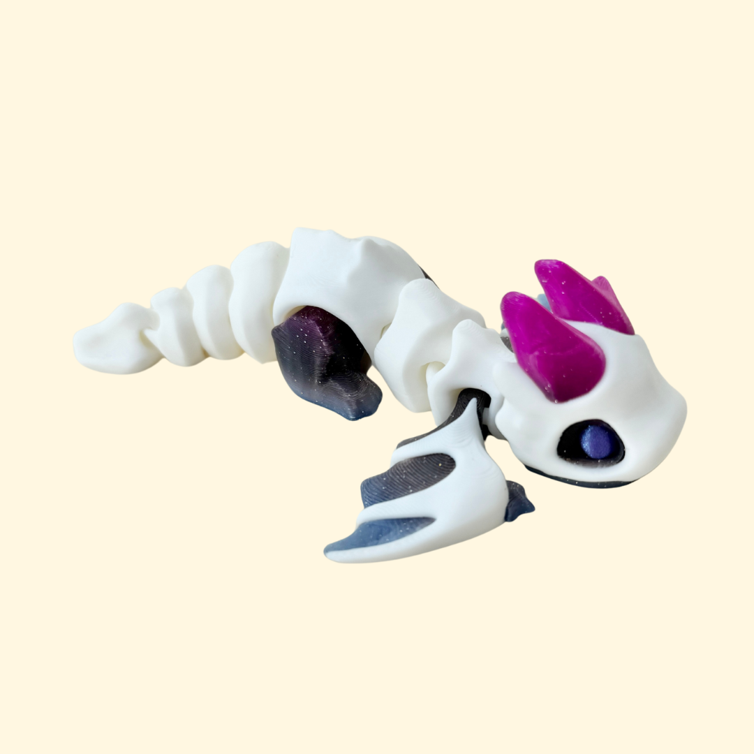 Articulated dragon fidget toy with moving wings and jointed body for quiet tactile stimming; limited-edition finish; approx. 14 cm.
