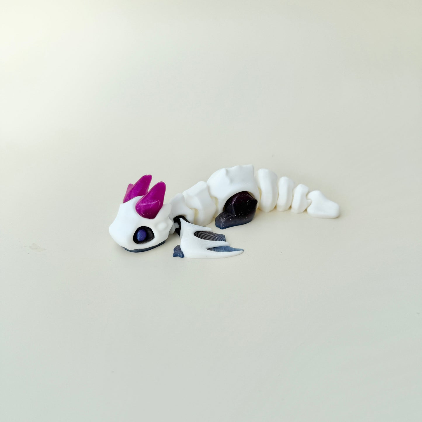 Winged dragon fidget with smooth links and gentle texture for repetitive motion and focus; collectable, limited edition.