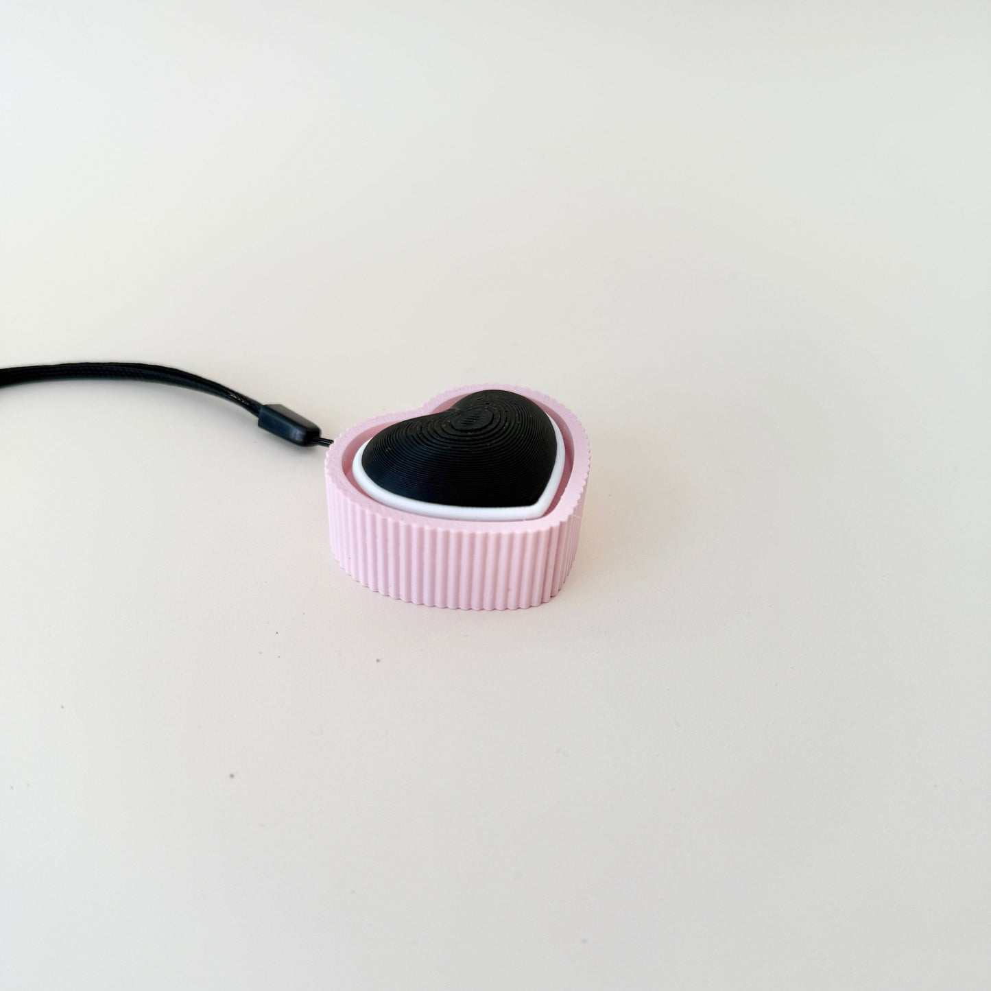 A modern and practical fidget toy with a heart shape and pop-click mechanism.