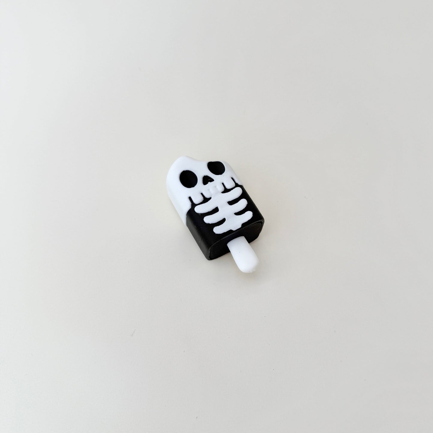 clicker fidget with raised bone details for thumb tracing and regulation