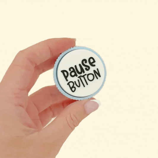 Sensory teacher clicker with textured edge and clickable top, available in pastel colours with various teacher-themed phrases