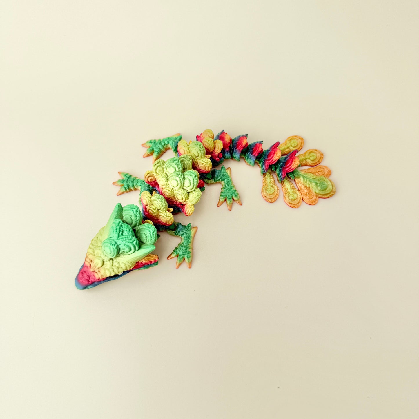dragon-shaped sensory figure featuring layered feather-like scales and smooth movement for tactile regulation