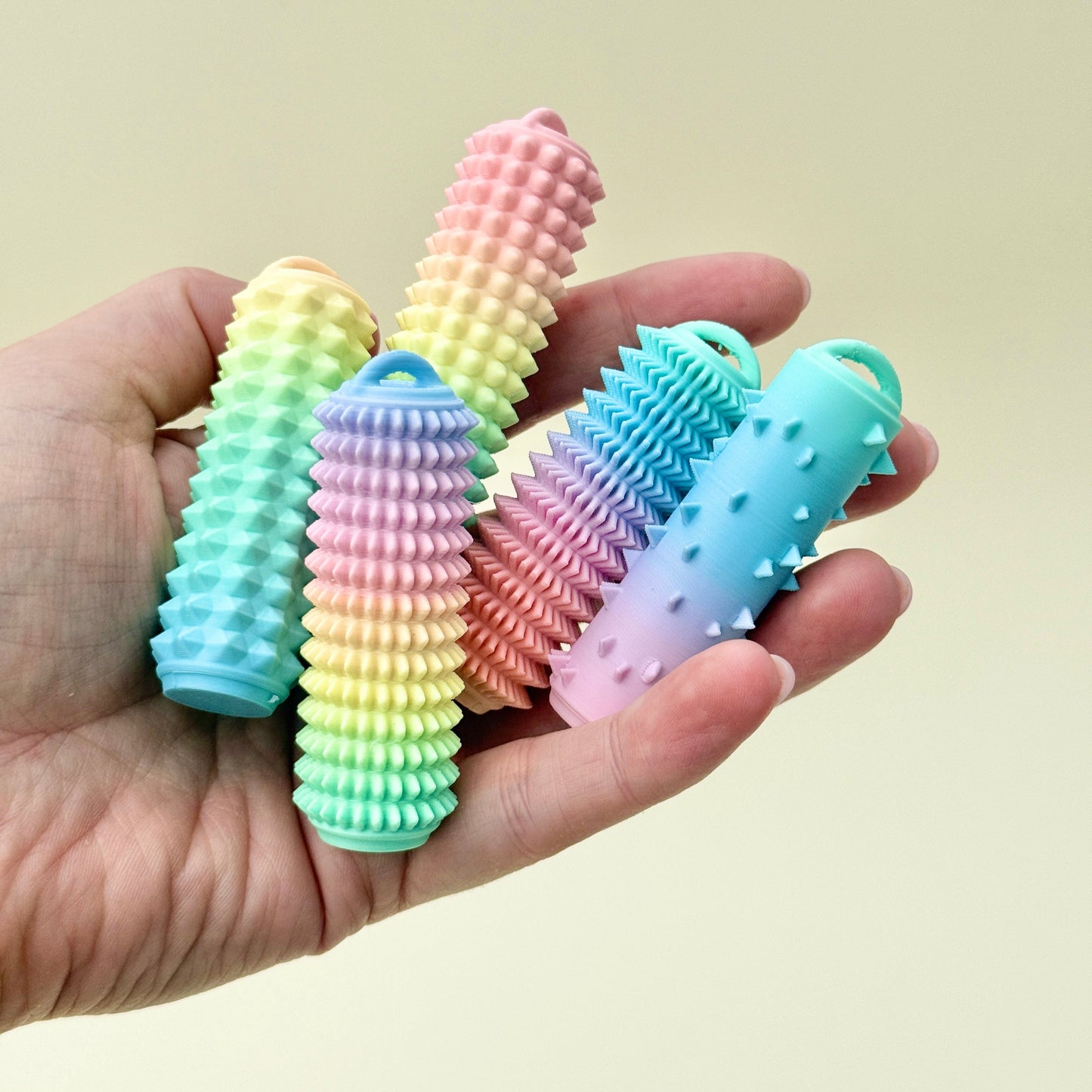 Rigid palm-sized fidget tool with varied textures for sensory support and tactile input.