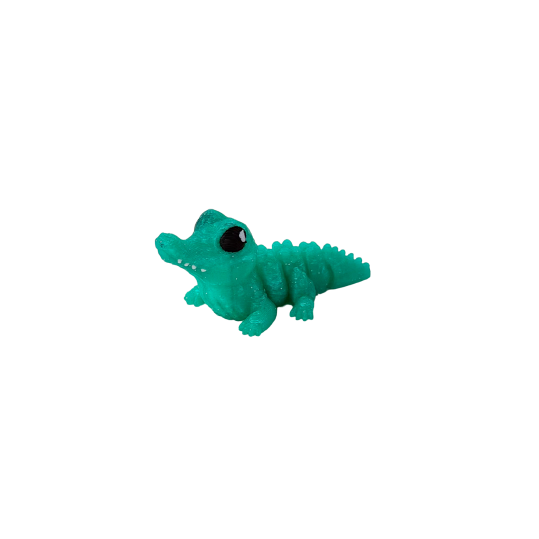Articulated mini creature fidget with soft clack, tactile scales and calm, loopable tail for discreet sensory regulation.