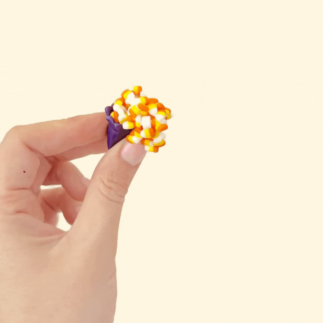 Compact Halloween desk toy showing candy corn pieces on an articulated chain for gentle stimming.