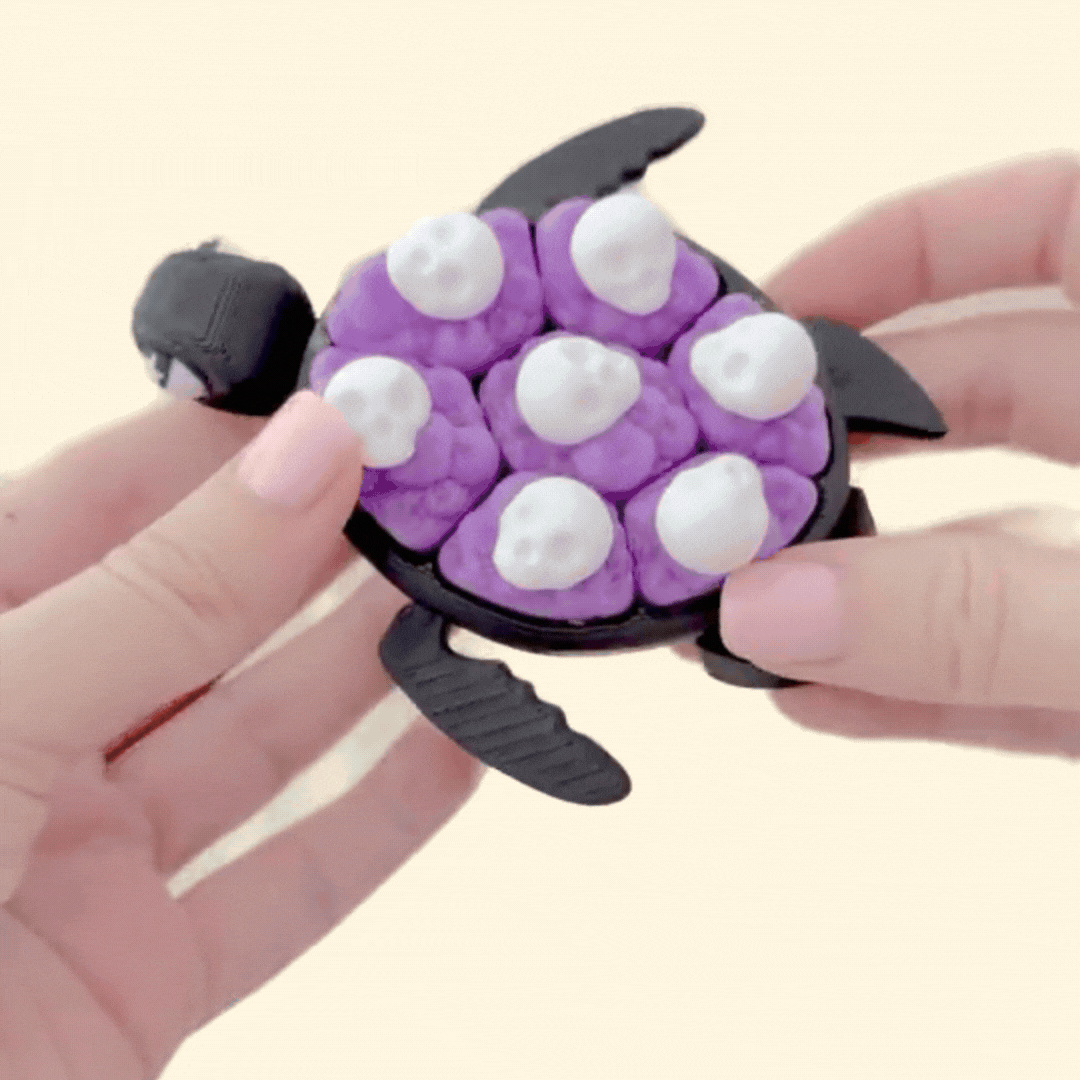 handheld sensory clicker with articulated turtle shape and pop tiles