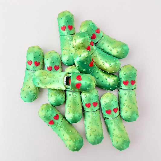 Valentine’s pickle fidget toy with heart eyes, a shiny finish, and interactive mouth movement.