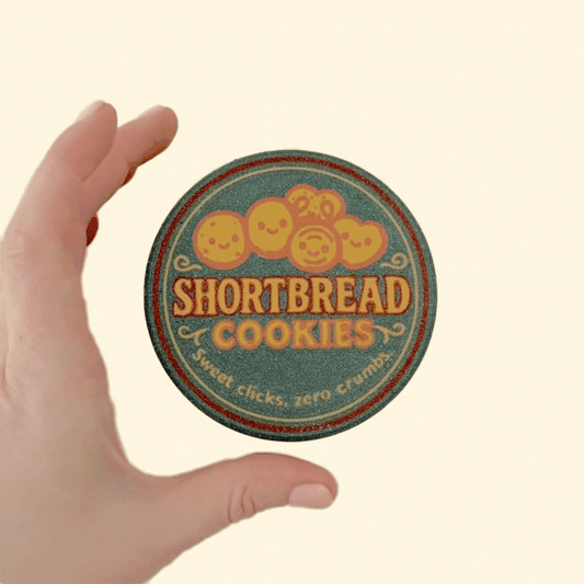 Compact round tin holding five individual clickers in faux paper cups; grounding sensory fidget for neurodivergent users.