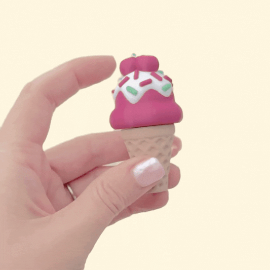 Close, generic view of a cone-style fidget clicker showing raised waffle texture and smooth dome for pressing.