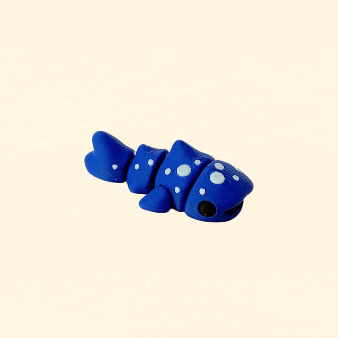Dark blue whale shark fidget toy with light blue spots, black eyes, and a black mouth, fully articulated for sensory play.