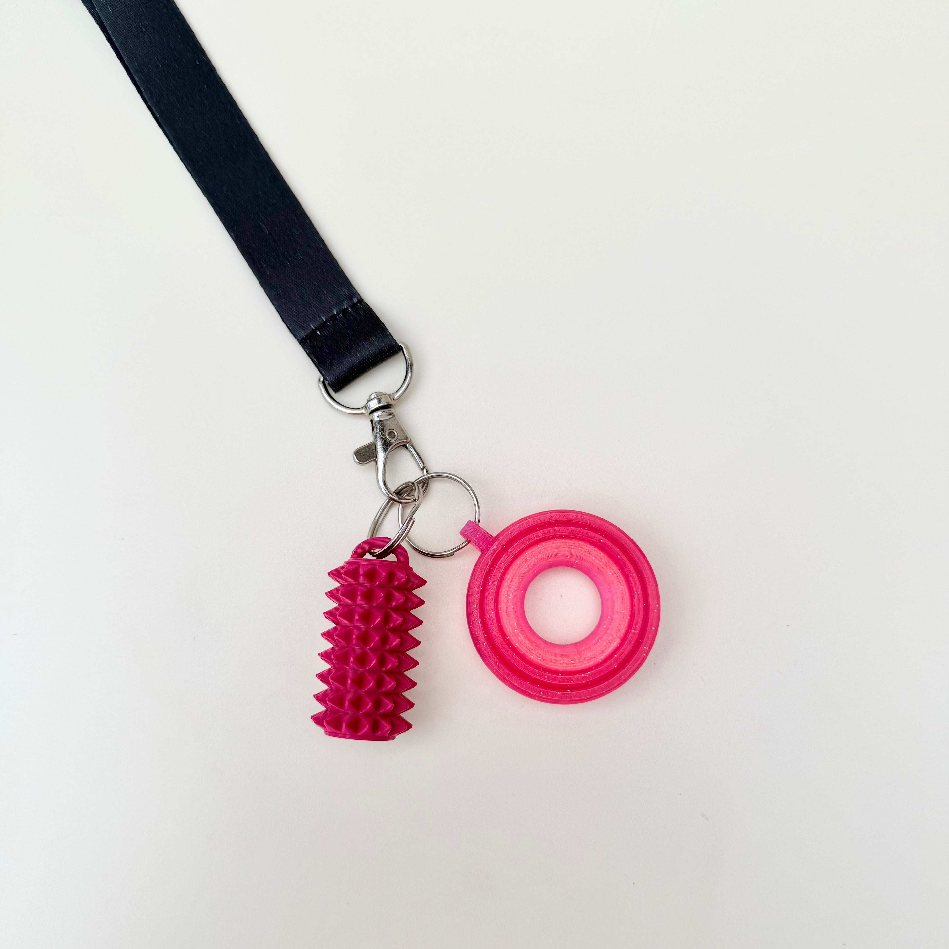 Clip-on spinner accessory that stays attached to your lanyard so it’s less likely to get lost in bags or pockets.
