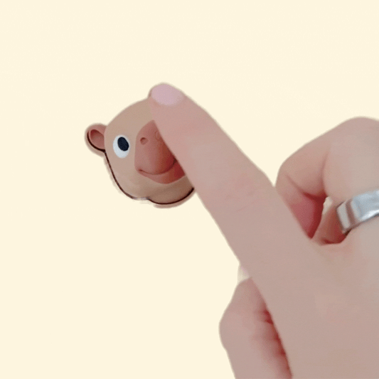 A handheld animal-shaped clicker designed for calm, repetitive sensory input.
