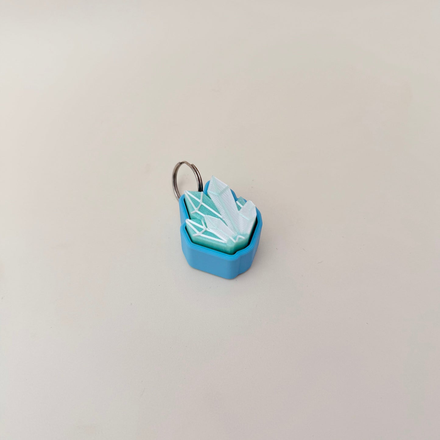 Shimmery crystal cluster clicker; tactile geometry for sensory input; attaches to keys, bags and lanyards.