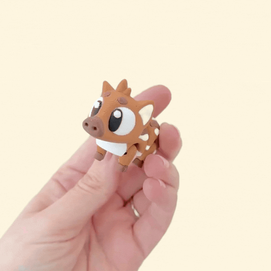 A flexible fidget toy shaped like a baby boar with a movable head, legs, and body.