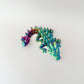 Small, articulated dragon fidget toy with colour-changing effects and flexible body for sensory play.