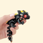Flexible black dragon fidget toy with vibrant rainbow accents, red eyes, and moveable design.