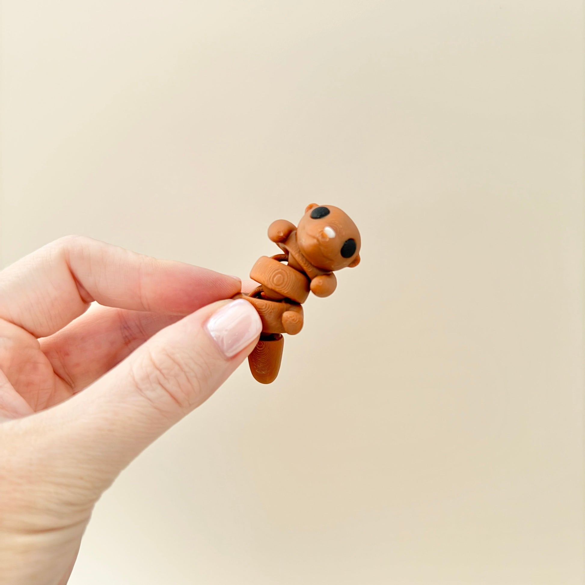 6cm otter fidget toy available in two positions, tummy up or on front, with flexible limbs.