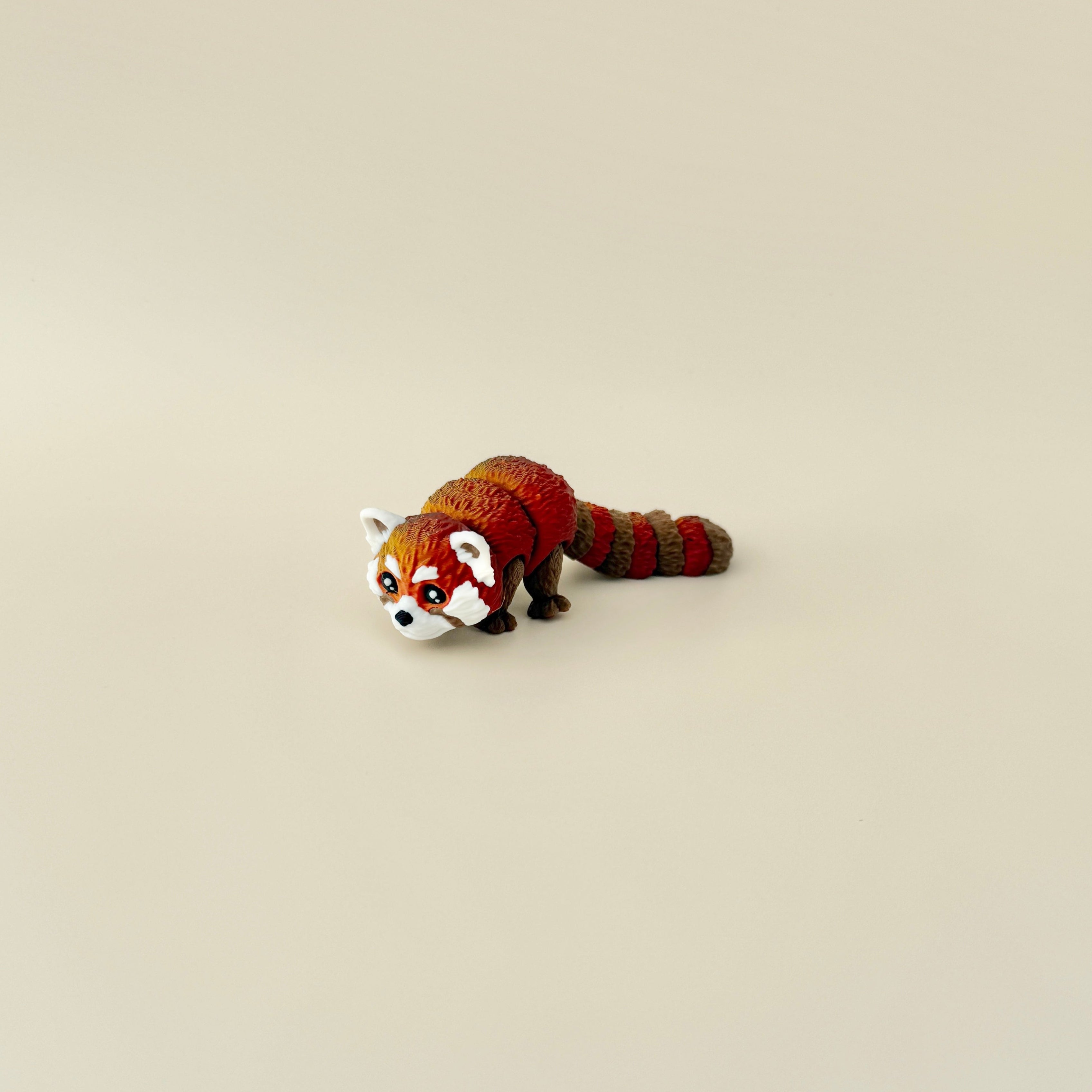 Fully articulated red panda fidget toy posed standing, highlighting its moveable legs, tail, and lifelike design.