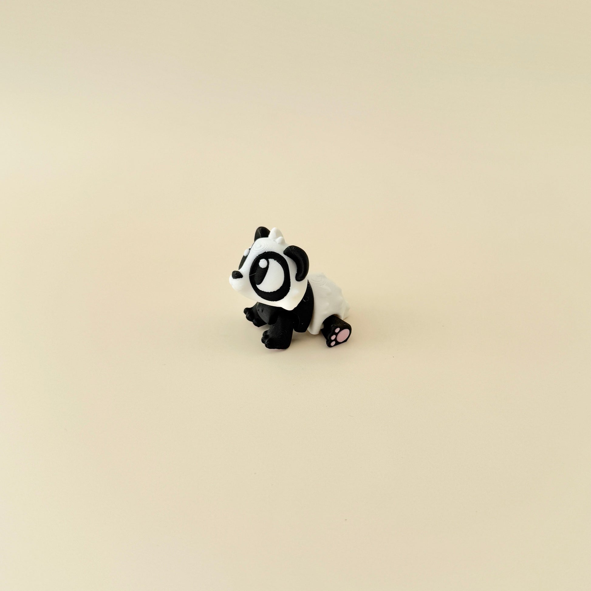 A flexible, hand-sized panda fidget toy designed for sensory engagement and stress relief.