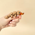 Textured brown platypus fidget toy with realistic details, black and white eyes, and a moveable body.