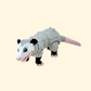 Close-up of the possum fidget toy showcasing its fully articulated movement, including a ball-jointed head and opening mouth.