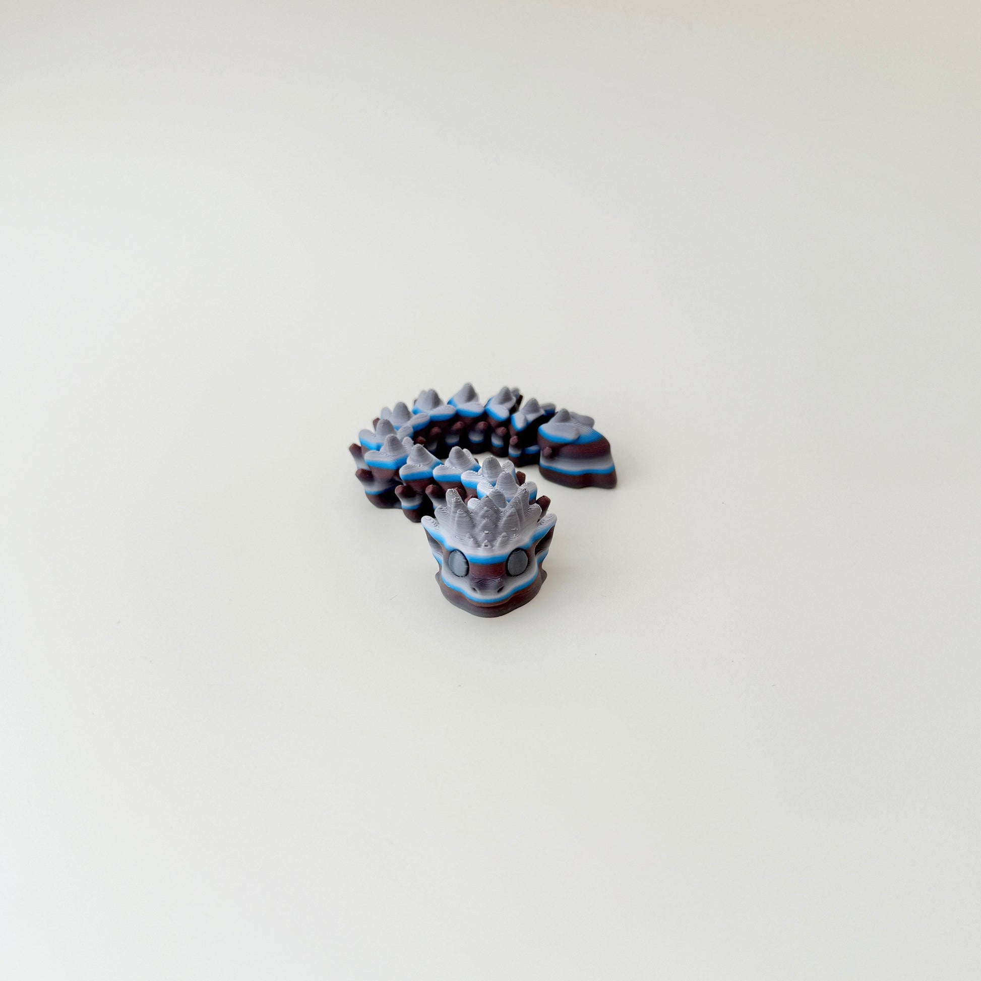Flexible snake figure with textured segments and spooky Halloween style

