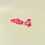 Baby Unicorn fidget toy featuring flexible movement and magical coral or rainbow designs.