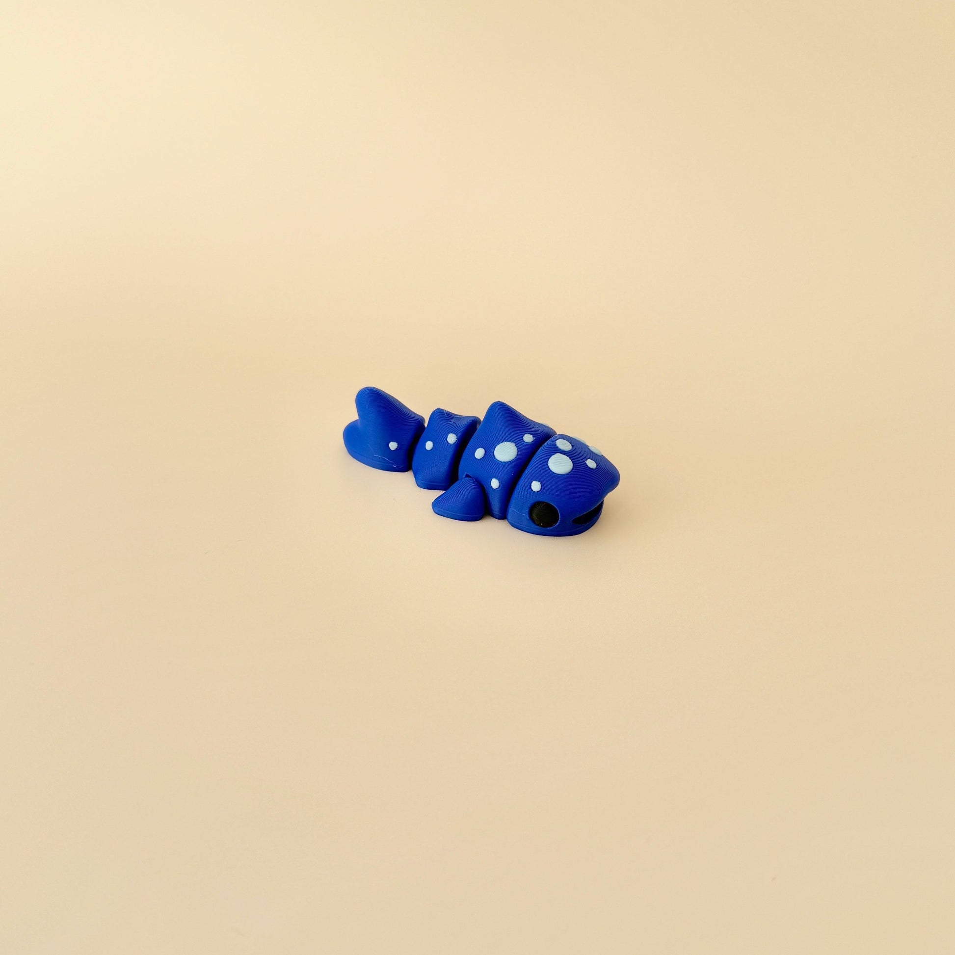 Marine-inspired fidget toy shaped like a whale shark, featuring a moveable body for tactile play.