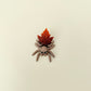 Compact 6 cm spider with freely moving legs and subtle textured ridges for tactile stimming.
