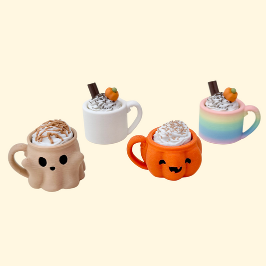 Mini mug clicker with cream topping and keyring loop for portable fidgeting.

