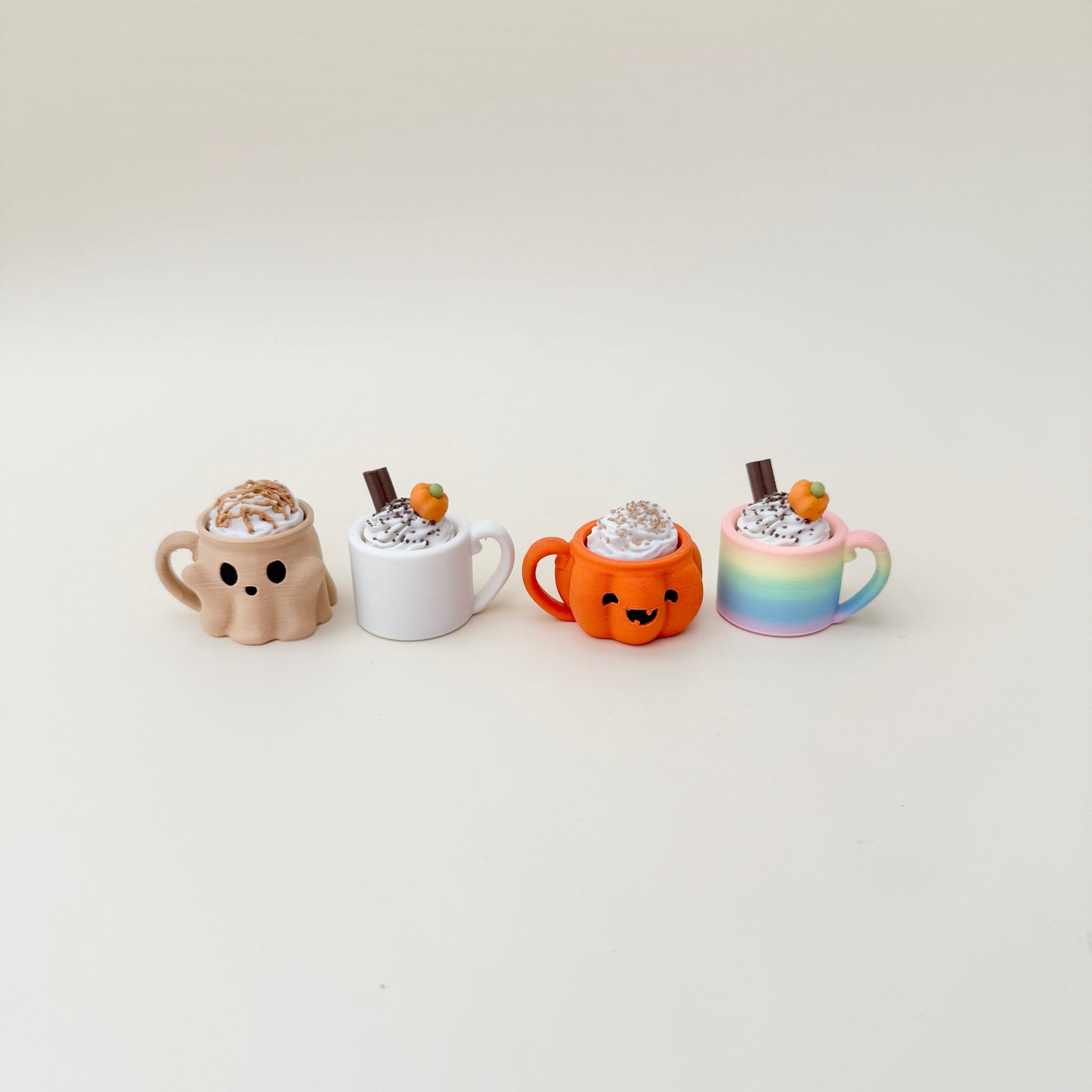 Mini mug clicker with cream topping and keyring loop for portable fidgeting.

