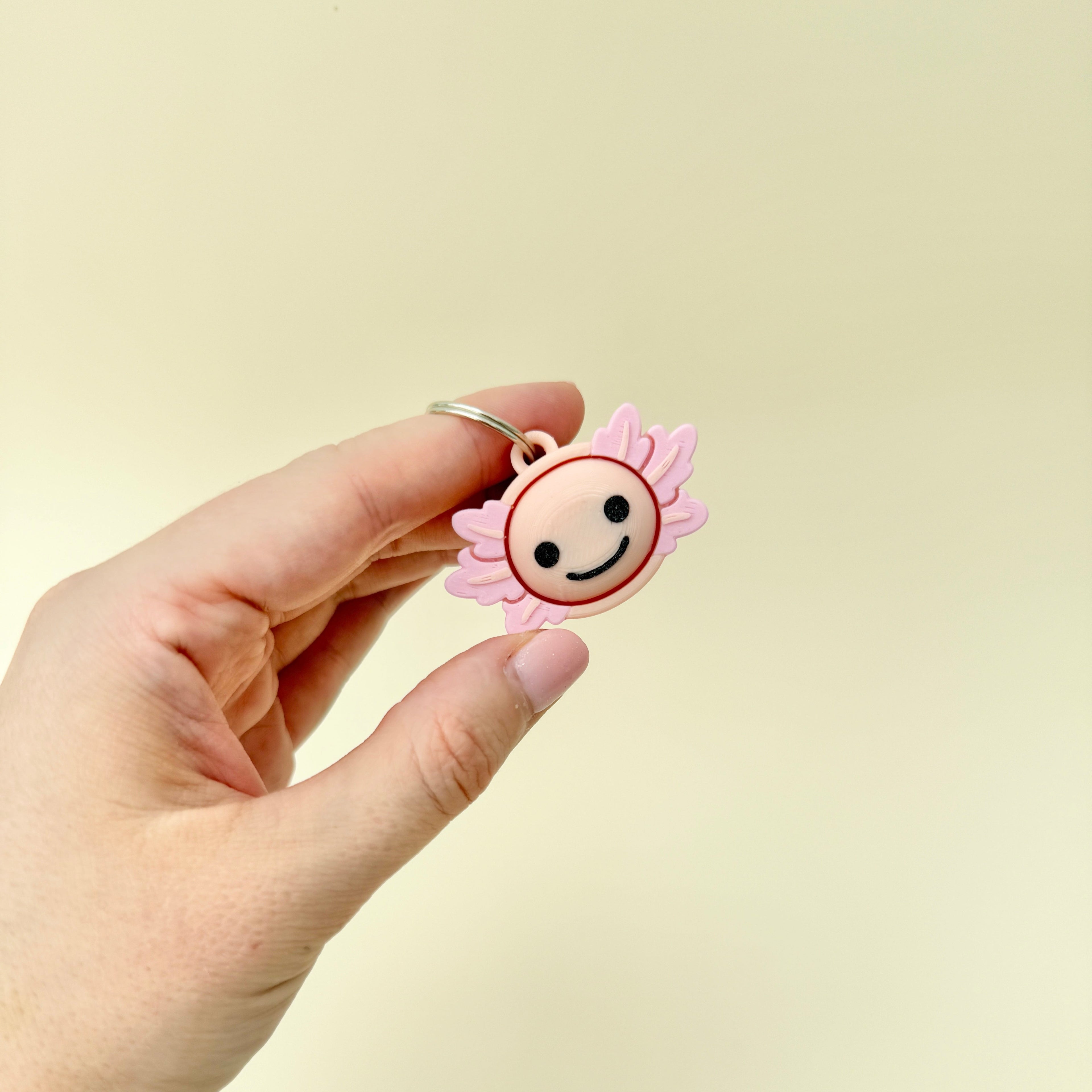 Fidget toy featuring axolotl-style design with clicker function.
