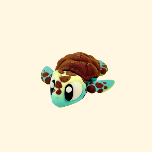 Articulated sea turtle fidget toy with gradient green and yellow tones and a textured shell.