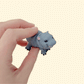 Small hard plastic baby hippo fidget toy for sensory play

